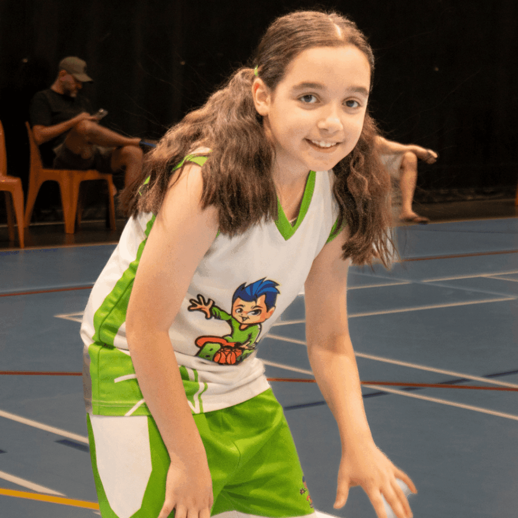 Child practising basketball dribbling at a kids school holiday sports camp