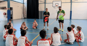 Franchise owner alongside a coach leading a Little Boomers session, engaging with children in a structured, playful activity.