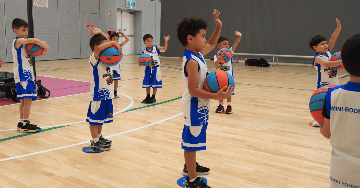 Young children engaged in a fun Little Boomers Basketball session during a group activity.