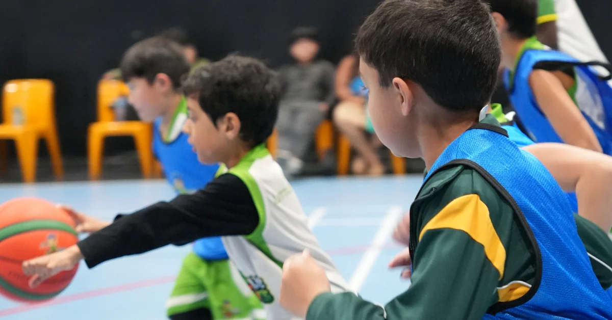 Children playing basketball during a Term 3 winter sports class.