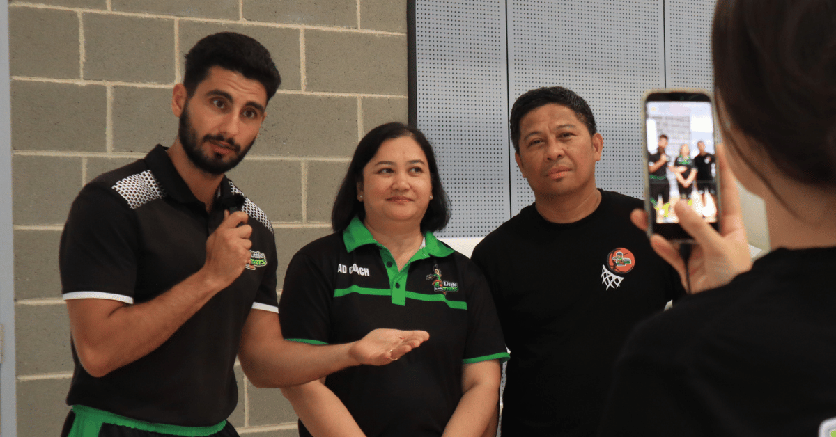 Emile Koorey, CEO of Little Boomers Basketball, standing with Mount Druitt franchise owners at the grand opening event.