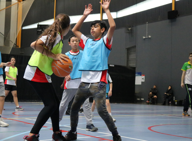 boys and girls playing basketball